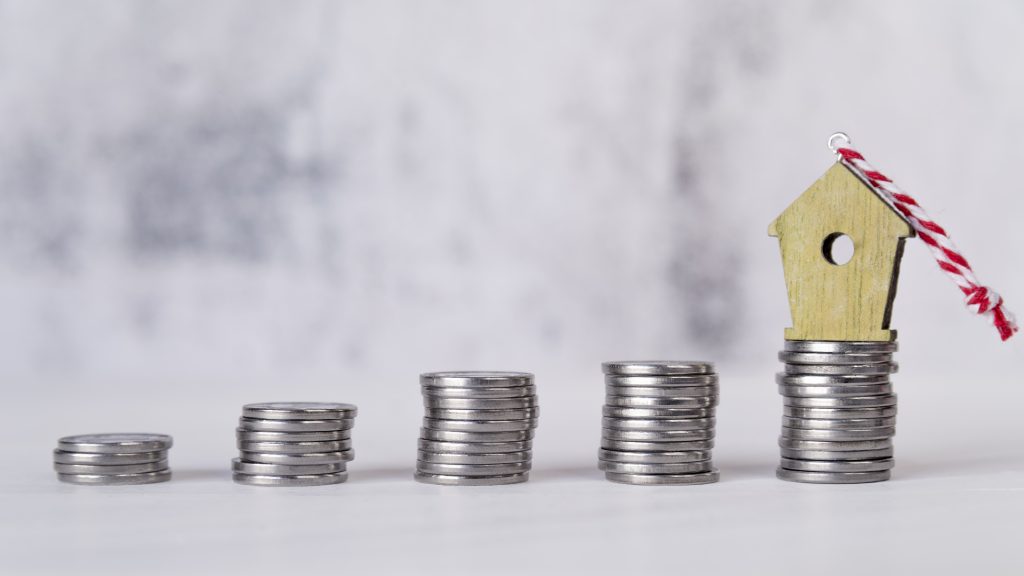 miniature birdhouse ornament increasing stacked silver coins